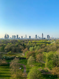 Scenic view of trees and buildings against clear sky