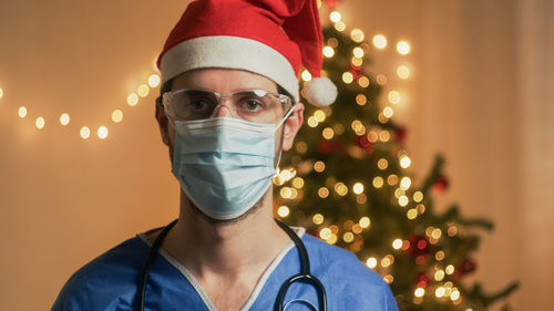 Doctor with mask on christmas background