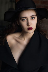 Portrait of beautiful young woman in hat