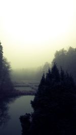 Scenic view of lake against sky during foggy weather