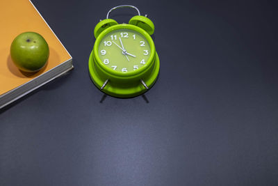 High angle view of clock on table