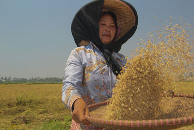 Full length of girl wearing hat on field against sky