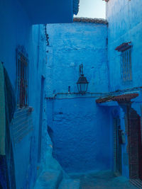 A little nook in the blue city of chefchaouen with a lantern and a hidden doorway