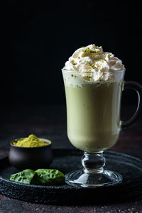 Close-up of dessert on table against black background