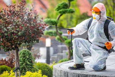 Rear view of man standing by plants