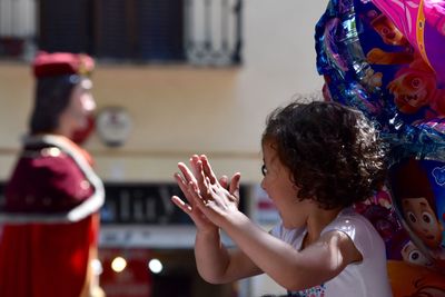 Close-up of cheerful girl clapping hands