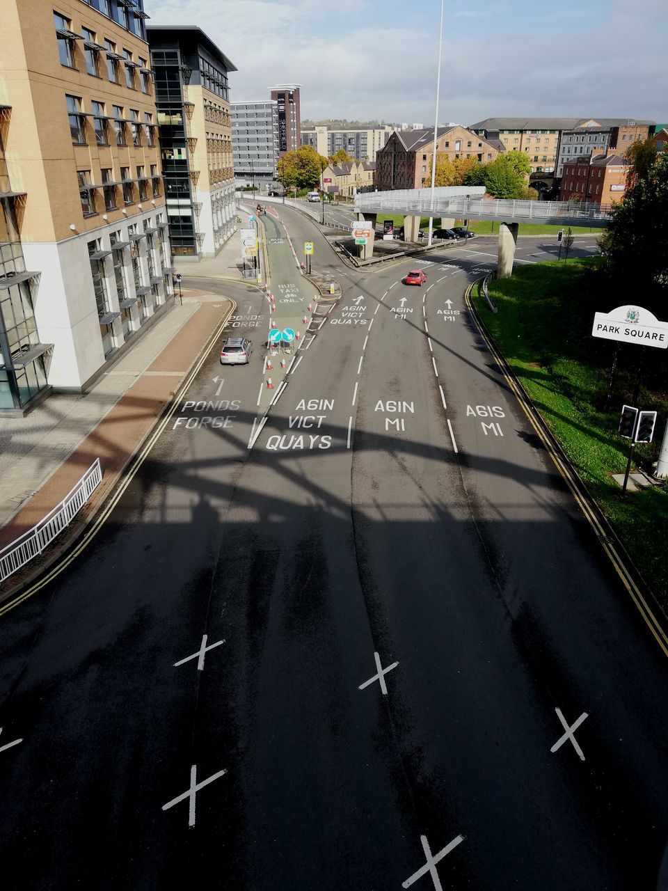 ROAD AMIDST BUILDINGS IN CITY