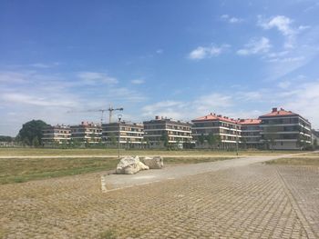 Empty road along buildings