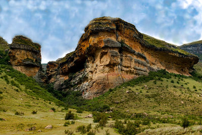 Rock formations on landscape against sky