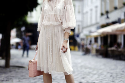 Woman walking on street in city