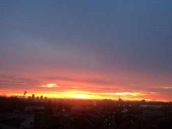 Cityscape against sky at sunset