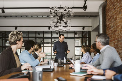 Businessman explaining product to team during meeting at office