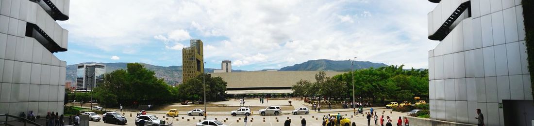 Panoramic view of people in city against sky