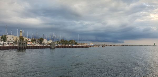 Scenic view of sea by buildings against sky