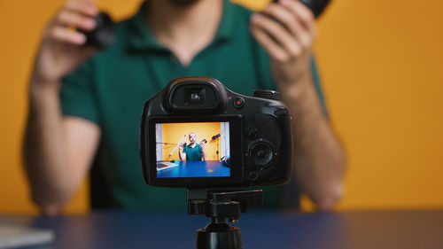 Midsection of woman holding camera