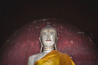 Statue of buddha against building