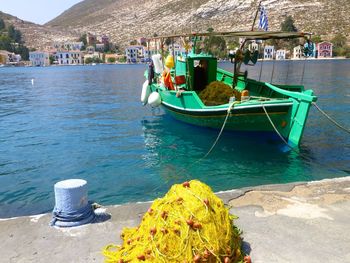 Fishing boat in sea with net on pier