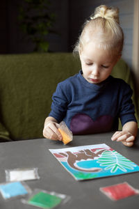 Portrait of cute baby girl studying at home