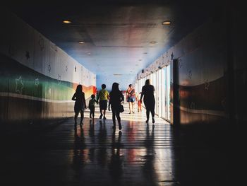 People walking in corridor at building