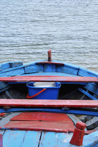 Close-up of boat moored in lake