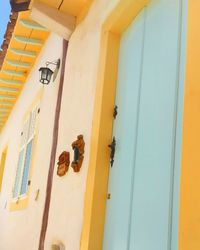 Low angle view of yellow window on building