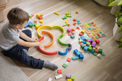 High angle view of boy playing with toys on table