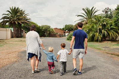 Rear view of couple walking on street