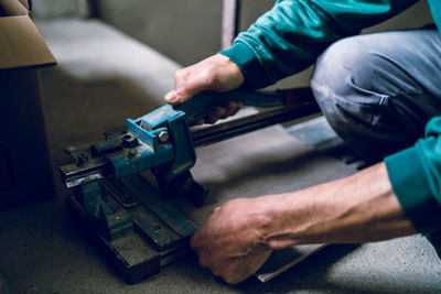 Midsection of man working at machine