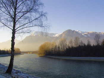 Scenic view of lake against clear sky during winter