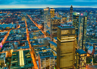 High angle view of illuminated buildings in city at dusk