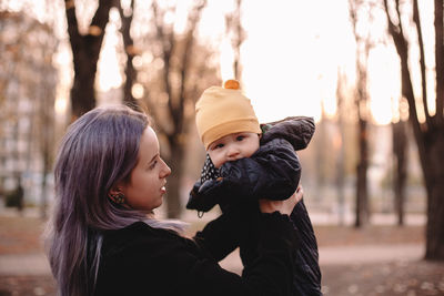 Portrait of mother and son on tree