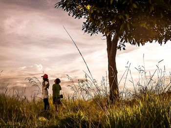 People standing on grassy field