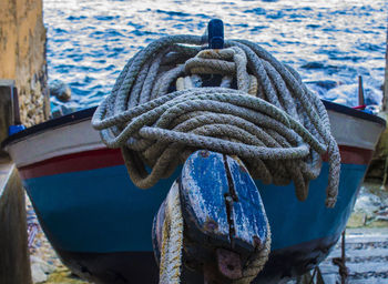 Close-up of rope tied to boat moored at harbor