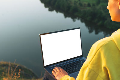 Midsection of woman using mobile phone