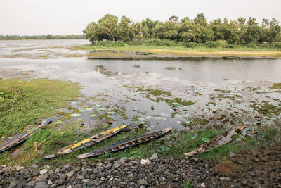 Scenic view of railroad tracks by lake