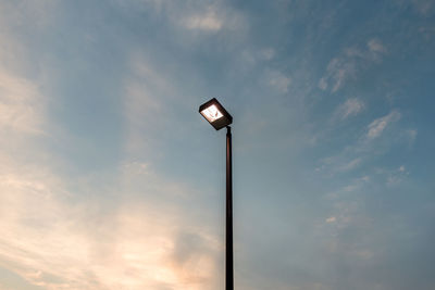 Low angle view of illuminated street light against sky