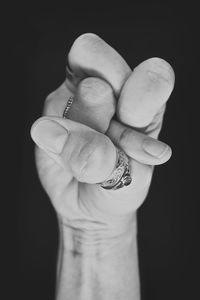 Close-up of human hand against black background