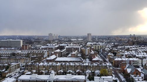 Aerial view of cityscape against sky during winter