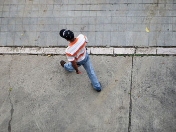 High angle view of man walking on footpath