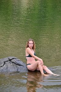 Portrait of woman sitting in water