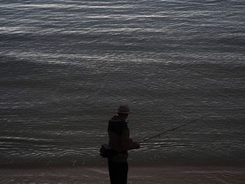 Rear view of man standing on beach