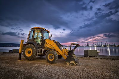 Construction site on field against sky at dusk