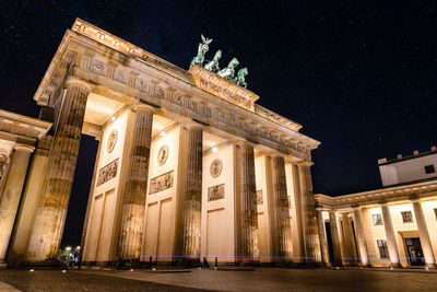 Low angle view of illuminated building at night