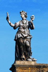 Low angle view of statue against blue sky