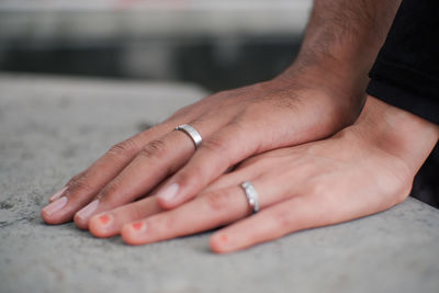 Midsection of couple holding hands