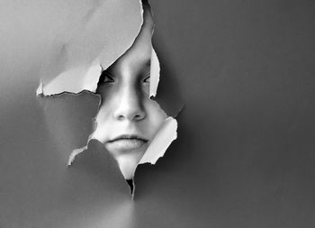 Close-up portrait of boy against wall