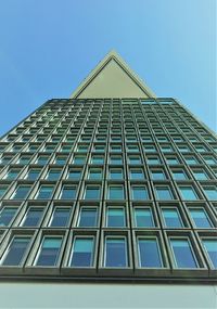 Low angle view of modern building against clear blue sky