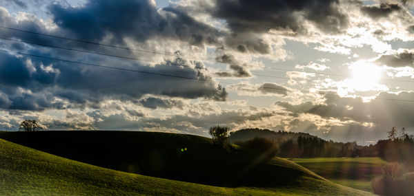 Scenic view of landscape against cloudy sky