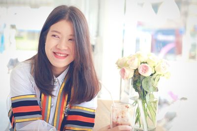 Portrait of smiling woman with flower petals