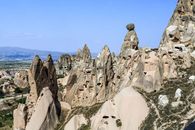 Panoramic view of landscape and mountains against blue sky